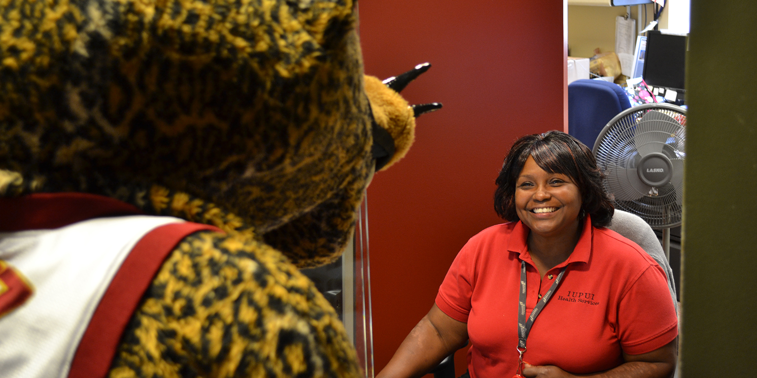 Jawz visits the front desk at student health in coleman hall.